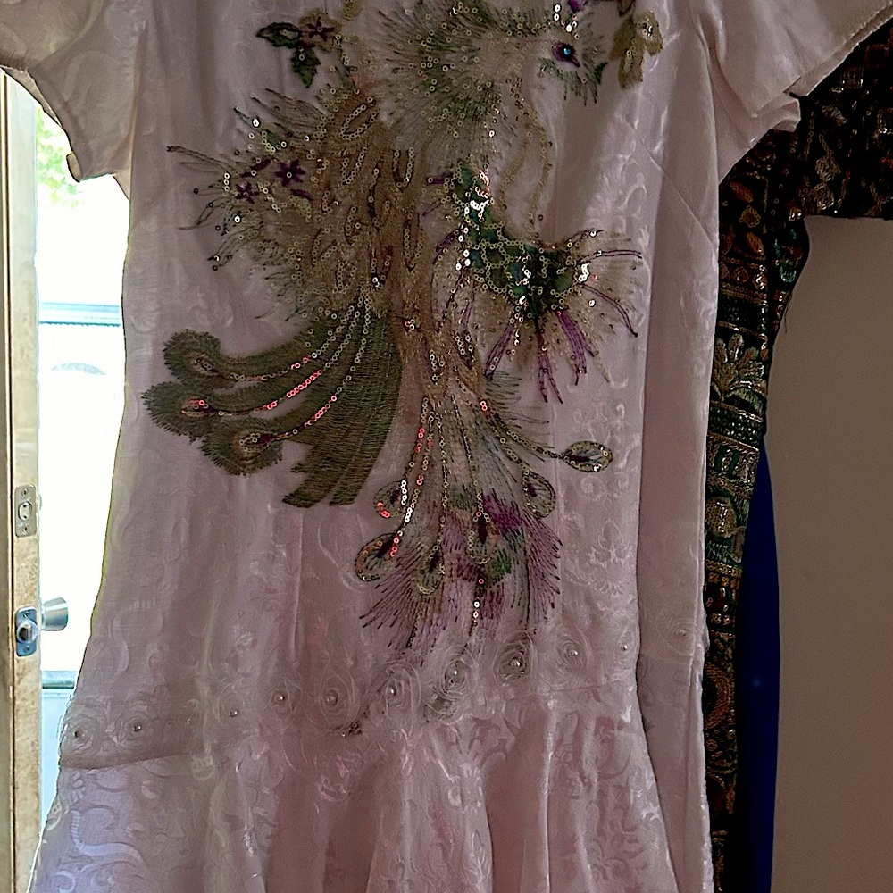 WhiteNylon feel Chinese dress with design on front.
